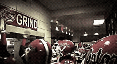 Football Helmets Lined Up Under Grind Sign GIF