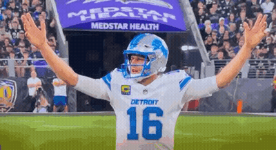 Football Player Arms Outstretched On Field GIF