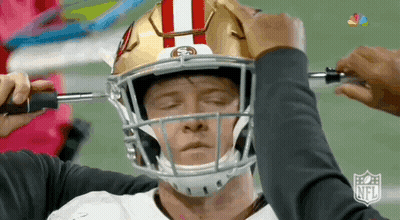 Football Player Being Adjusted By Person GIF