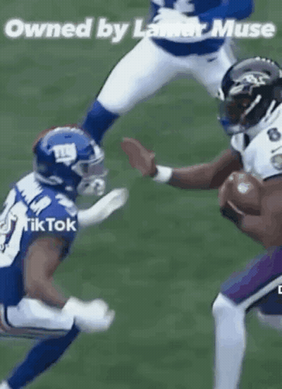 Football Player Being Tackled While Holding Ball