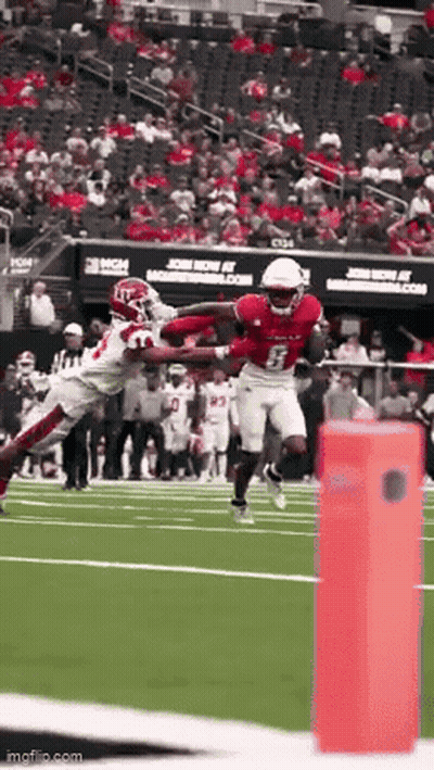 Football Player Catching Ball As Opponent Tackles GIF
