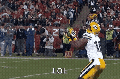 Football Player Catching Ball On Field With Crowd GIF