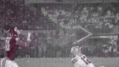 Football Player Catching Ball While Being Tackled GIF