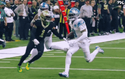 Football Player Catching Ball While Being Tackled GIF
