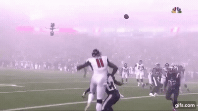 Football Player Catching Ball With Smoke From Stands GIF