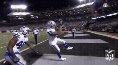 Football Player Catching Pass While Another Watches GIF