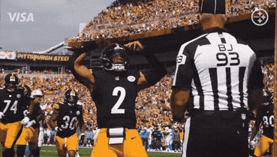 Football Player Fields Throwing Ball GIF