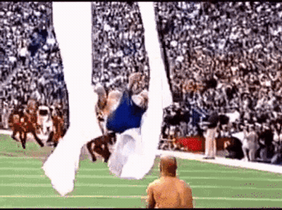 Football Player Flying Through Air GIF