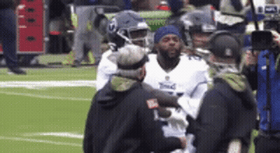 Football Player Helped Off Field By Nurse GIF