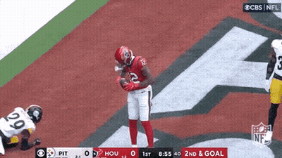 Football Player Holding Ball Over Lying Player GIF