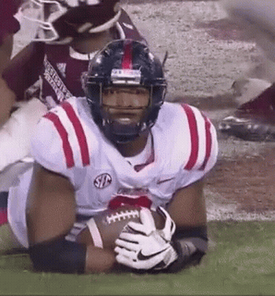 Football Player Holding Football On Field GIF