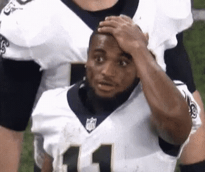 Football Player Holding Hand To Forehead On Field GIF
