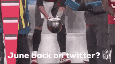 Football Player Holding Helmet In Front Of Crowd GIF