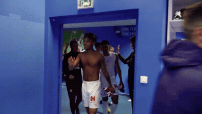 Football Player Holding Helmet In Front Of Crowd GIF