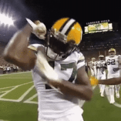 Football Player Holding Knife On Field GIF