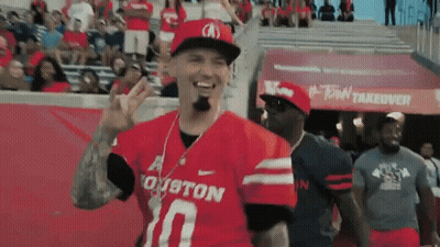 Football Player Holding Red Flag With Letter T GIF
