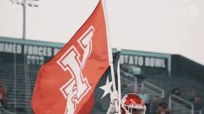 Football Player Holding Red Flag With Letter T GIF