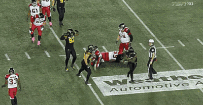 Football Player In Black Jersey With Yellow Stripes GIF