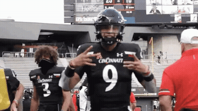 Football Player In Black Uniform Number 9 Giving Peace Sign GIF