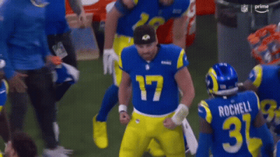 Football Player In Blue And Yellow Uniform Holding Helmet GIF