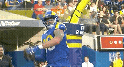 Football Player In Blue And Yellow Uniform Running With Ball GIF