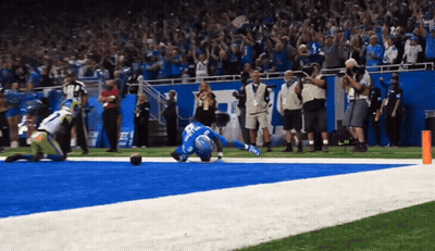 Football Player In Blue Jersey Number 22 Laying On Field GIF