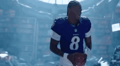 Football Player In Blue Uniform Holding Football GIF