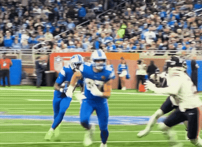Football Player In Blue Uniform Running With Ball GIF