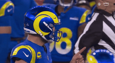 Football Player In Blue Yellow Helmet Pointing At Referee GIF