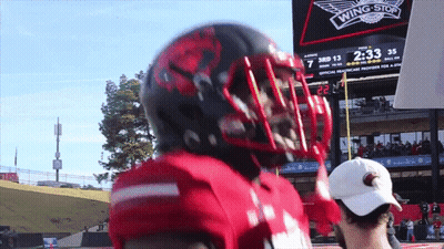 Football Player In Front Of Scoreboard Saying Wing Stop GIF