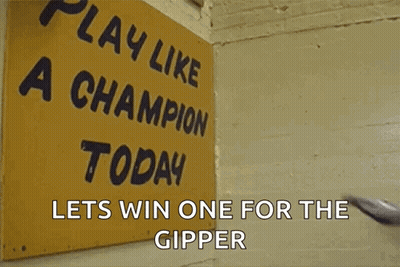 Football Player In Front Of Sign Saying Play Like A Champion Today Lets Win One For The Gipper GIF