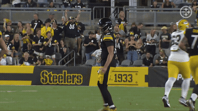 Football Player in Front of Steelers Banner