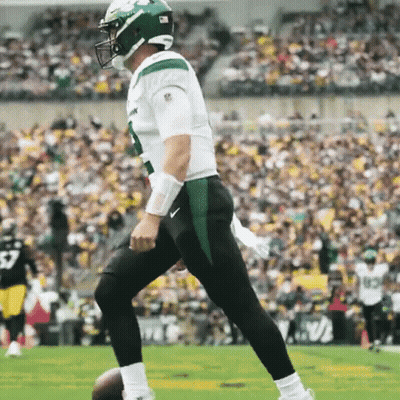 Football Player In Green Helmet Kicking Ball GIF