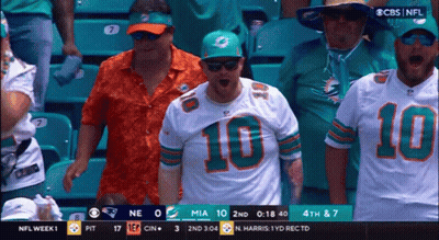 Football Player In Helmet And Gloves Covering Mouth GIF