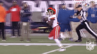Football Player In Helmet And Sunglasses Running Past Referee GIF