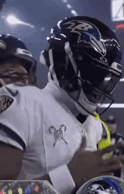 Football Player In Helmet And White Jersey Standing On Field GIF