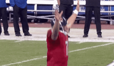 Football Player In Helmet Holding American Flag GIF