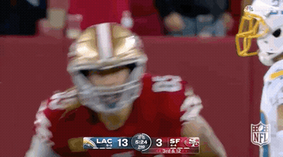 Football Player In Helmet In Front Of Scoreboard GIF