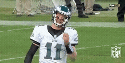 Football Player In Helmet Standing On Field GIF