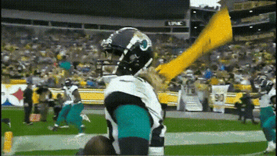 Football Player In Jaguars Uniform Holding Yellow Flag GIF
