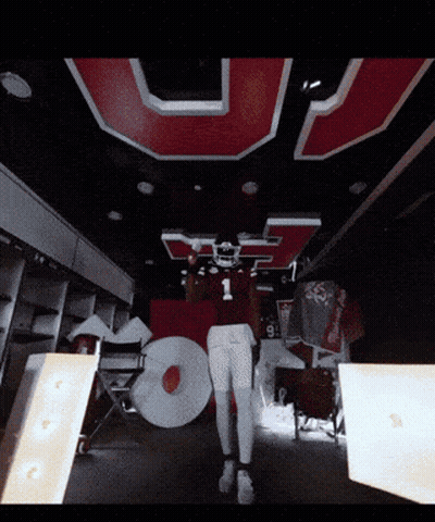 Football Player In Number 1 Jersey In Front Of Large U GIF