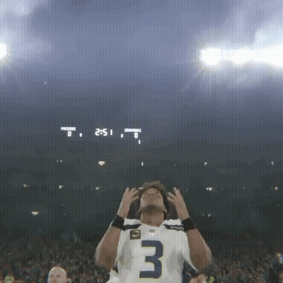 Football Player in Number 3 Jersey in Front of Scoreboard