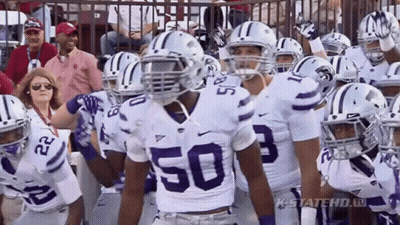 Football Player In Number 50 Jersey In Huddle GIF