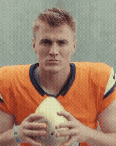 Football Player In Orange Jersey Holding Football GIF
