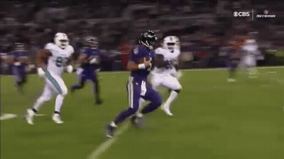 Football Player In Purple Jersey Being Tackled GIF