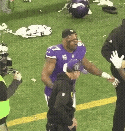 Football Player In Purple Jersey With Police Officer GIF