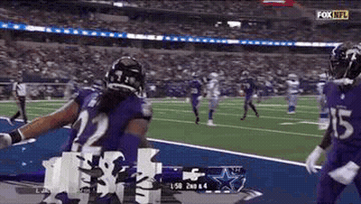 Football Player In Purple Uniform Celebrating Touchdown GIF