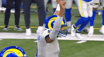 Football Player In Rams Helmet Kneeling On Field GIF