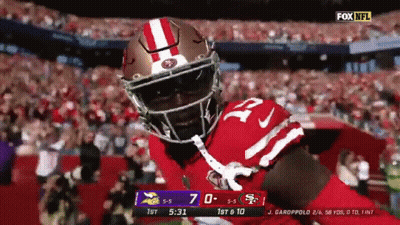 Football Player In Red And White Helmet In Front Of Crowd GIF