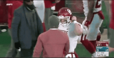 Football Player In Red Helmet Next To Man In Red Shirt GIF